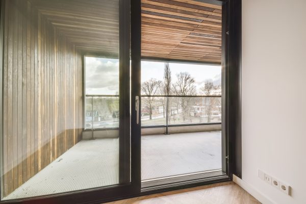 Delightful design of a room with a glass door leading to a balcony
